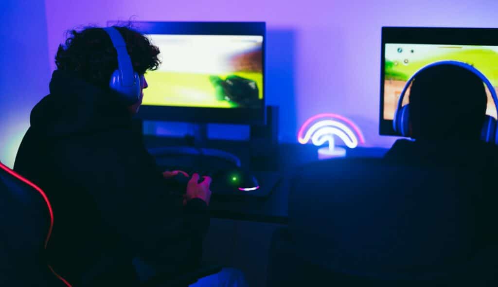 Young gamers playing at e-sports competition at official tournament